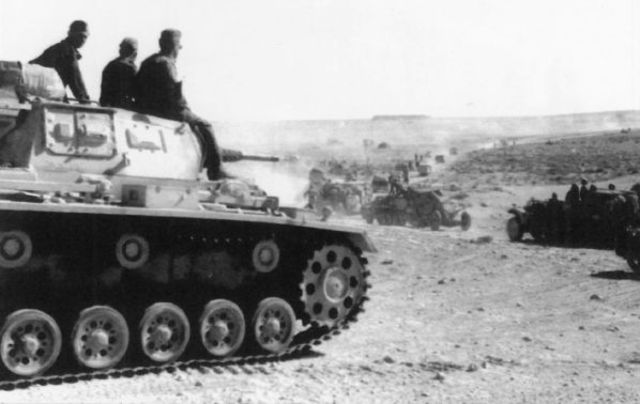 Un Panzer III del la 21st Panzer Division protegiendo una columna de vehículos en la línea de El Alamein